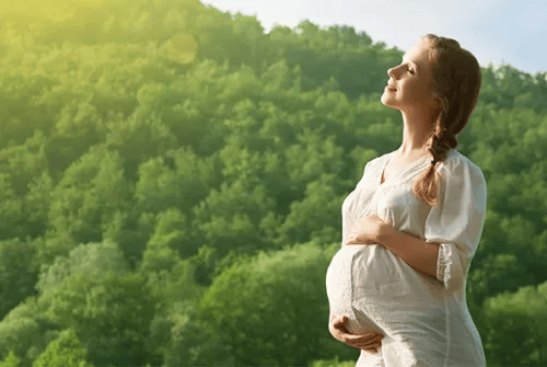 Pregnant woman in sunlight, highlighting the importance of Vitamin D for bone health during pregnancy.